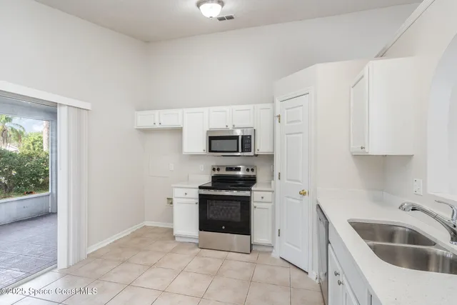 a kitchen with granite countertop a sink and stainless steel appliances