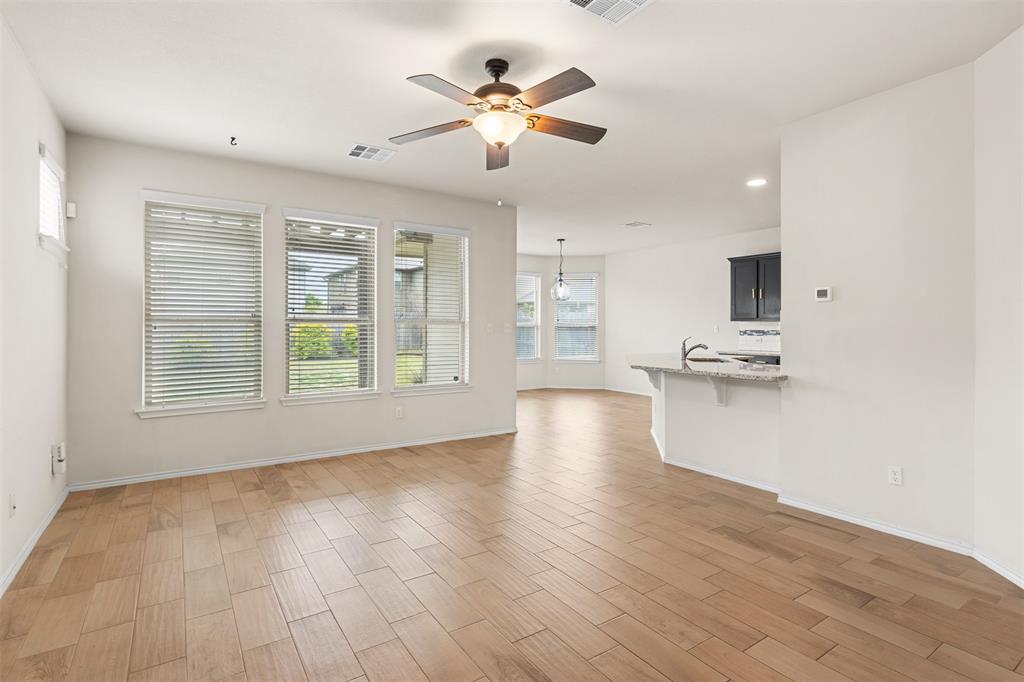 3560 Pauling Loop Round Rock, TX 78665 - Photo 14 of 28 Unfurnished living room featuring a ceiling fan, wood finish floors, and recessed lighting
