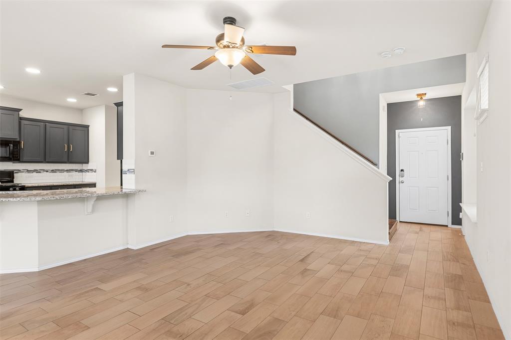 3560 Pauling Loop Round Rock, TX 78665 - Photo 16 of 28 Unfurnished living room featuring ceiling fan, wood tiled floors, and recessed lighting