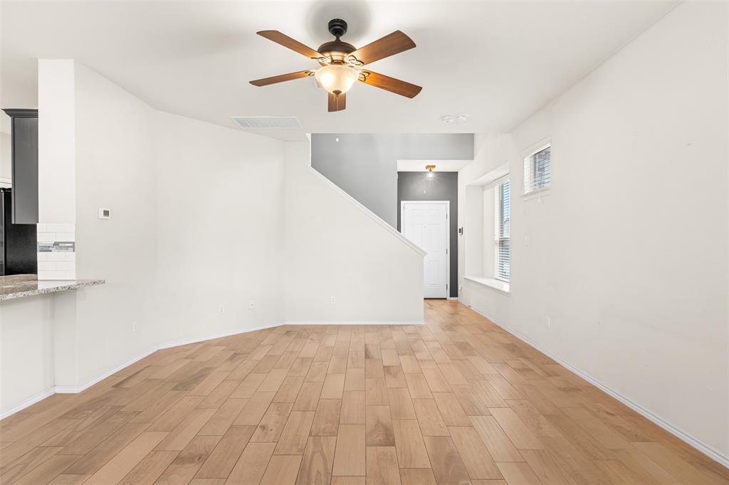 3560 Pauling Loop Round Rock, TX 78665 - Photo 17 of 28 Unfurnished living room featuring wood tiled floors and a ceiling fan