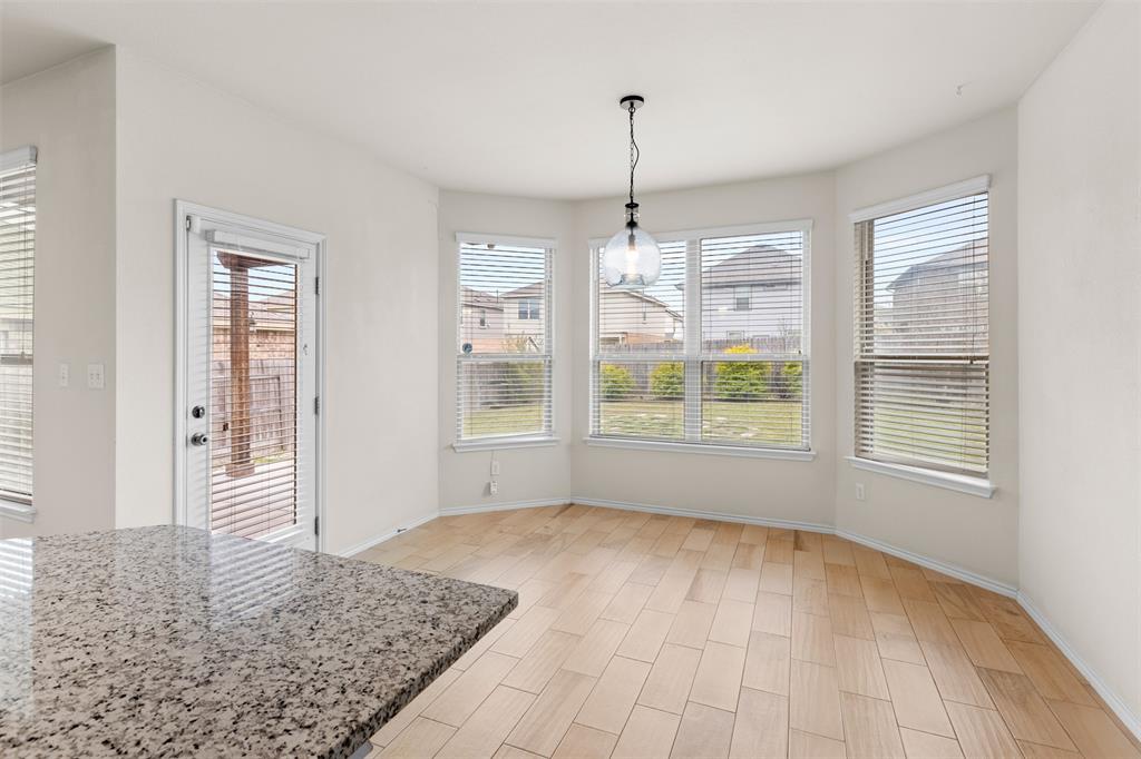 3560 Pauling Loop Round Rock, TX 78665 - Photo 19 of 28 Unfurnished dining area with wood finish floors and healthy amount of natural light