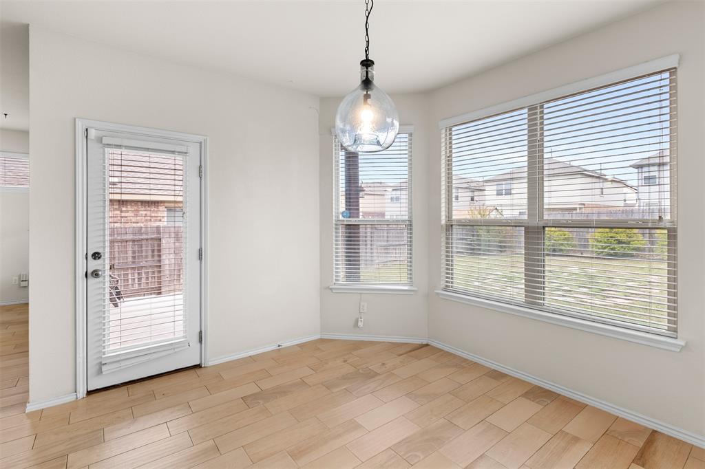 3560 Pauling Loop Round Rock, TX 78665 - Photo 20 of 28 Unfurnished dining area featuring wood finish floors and baseboards