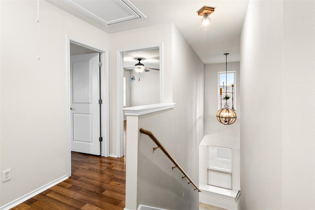 3560 Pauling Loop Round Rock, TX 78665 - Photo 23 of 28 Hall with an upstairs landing, dark wood-style flooring, and a chandelier