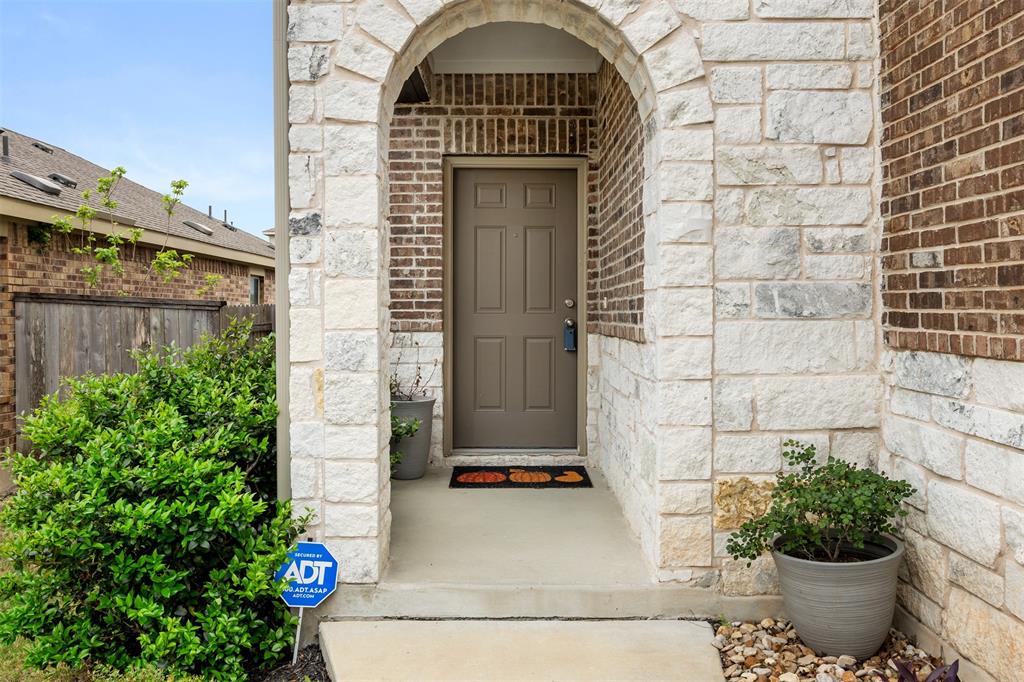 3560 Pauling Loop Round Rock, TX 78665 - Photo 28 of 28 Entrance to property featuring stone siding and brick siding