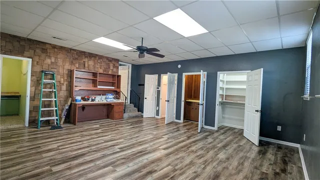 a room with a sink and wooden cabinets