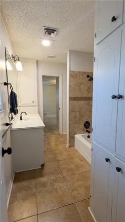 a bathroom with a granite countertop toilet and a shower