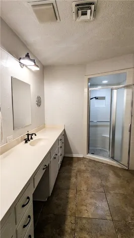 a spacious bathroom with a double vanity sink toilet mirror and bathtub