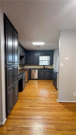 a large kitchen with stainless steel appliances granite countertop a refrigerator and a stove top oven