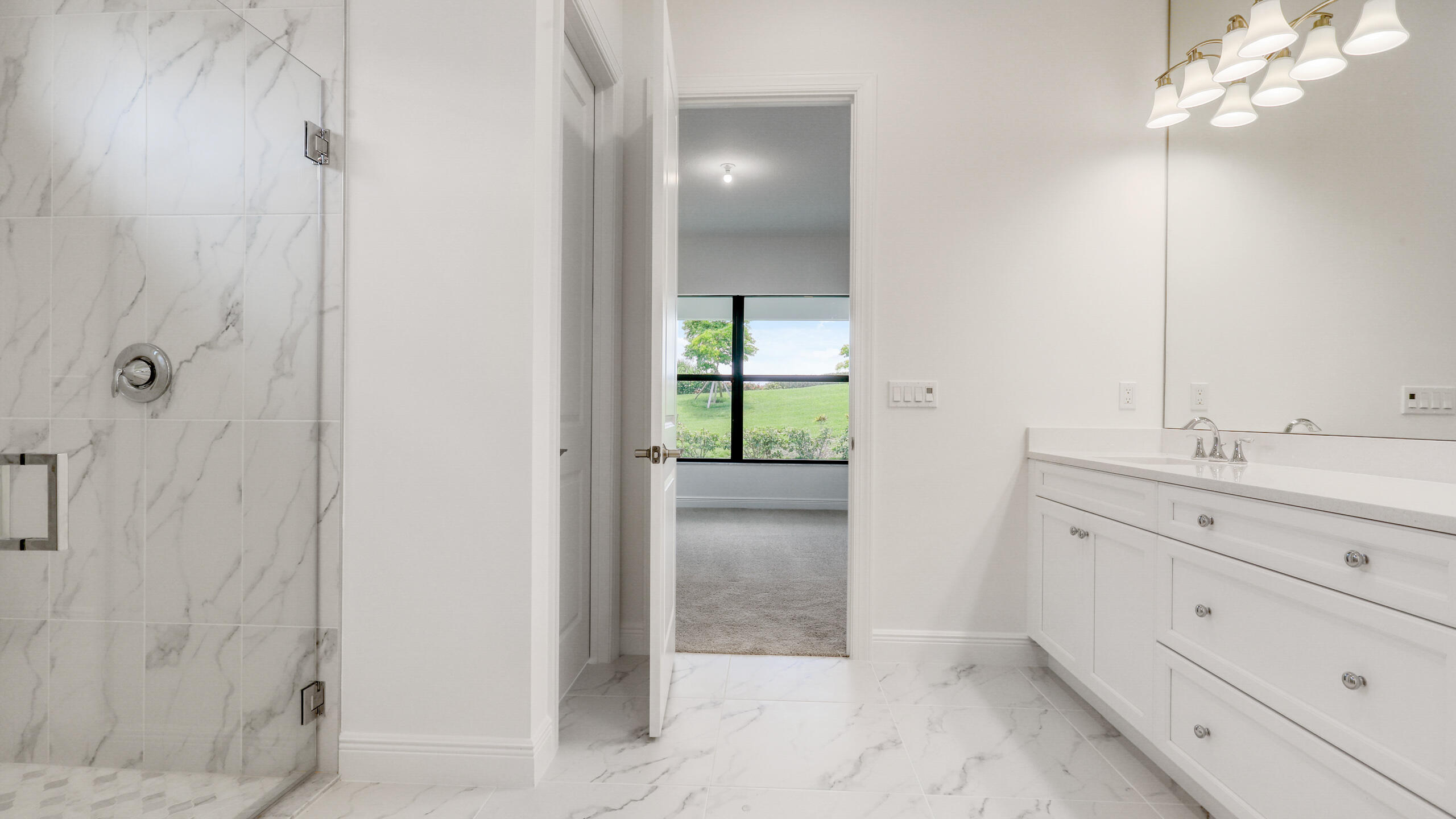 15850 Alys Terrace Westlake, FL 33470 - Photo 13 of 26 a bathroom with a shower sink and mirror