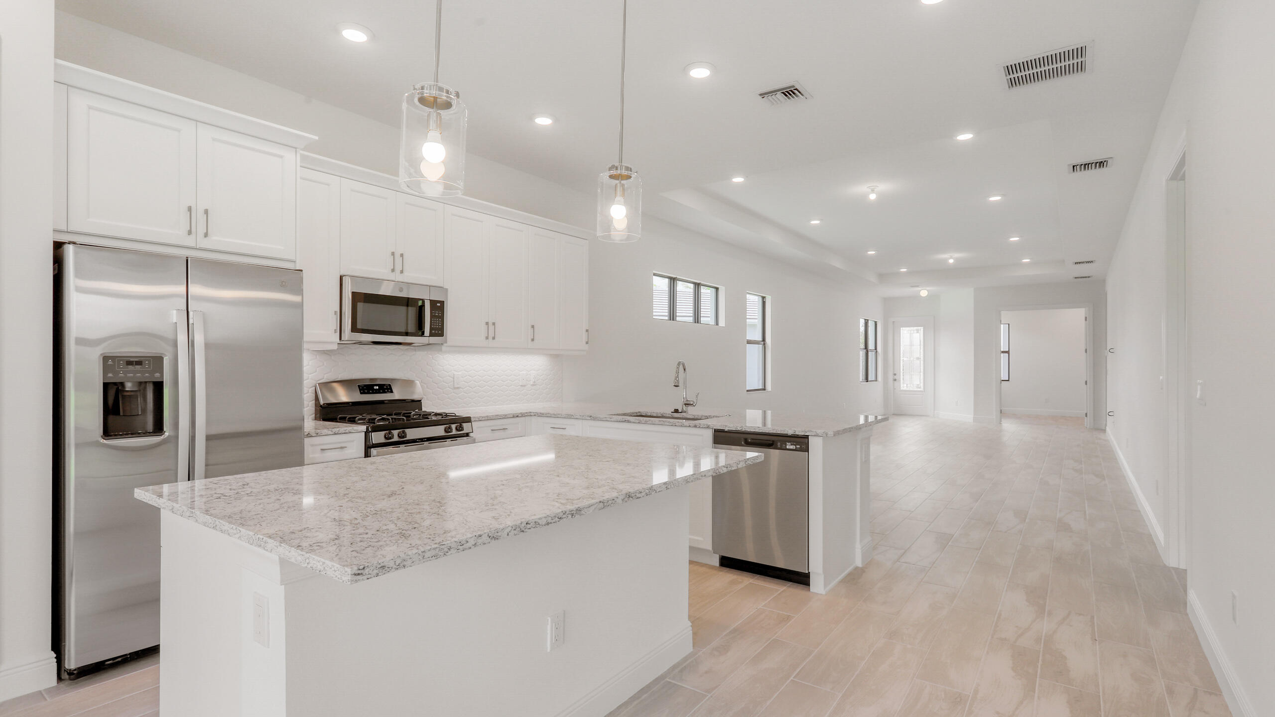 15850 Alys Terrace Westlake, FL 33470 - Photo 2 of 26 a kitchen with stainless steel appliances granite countertop a sink a stove and a refrigerator