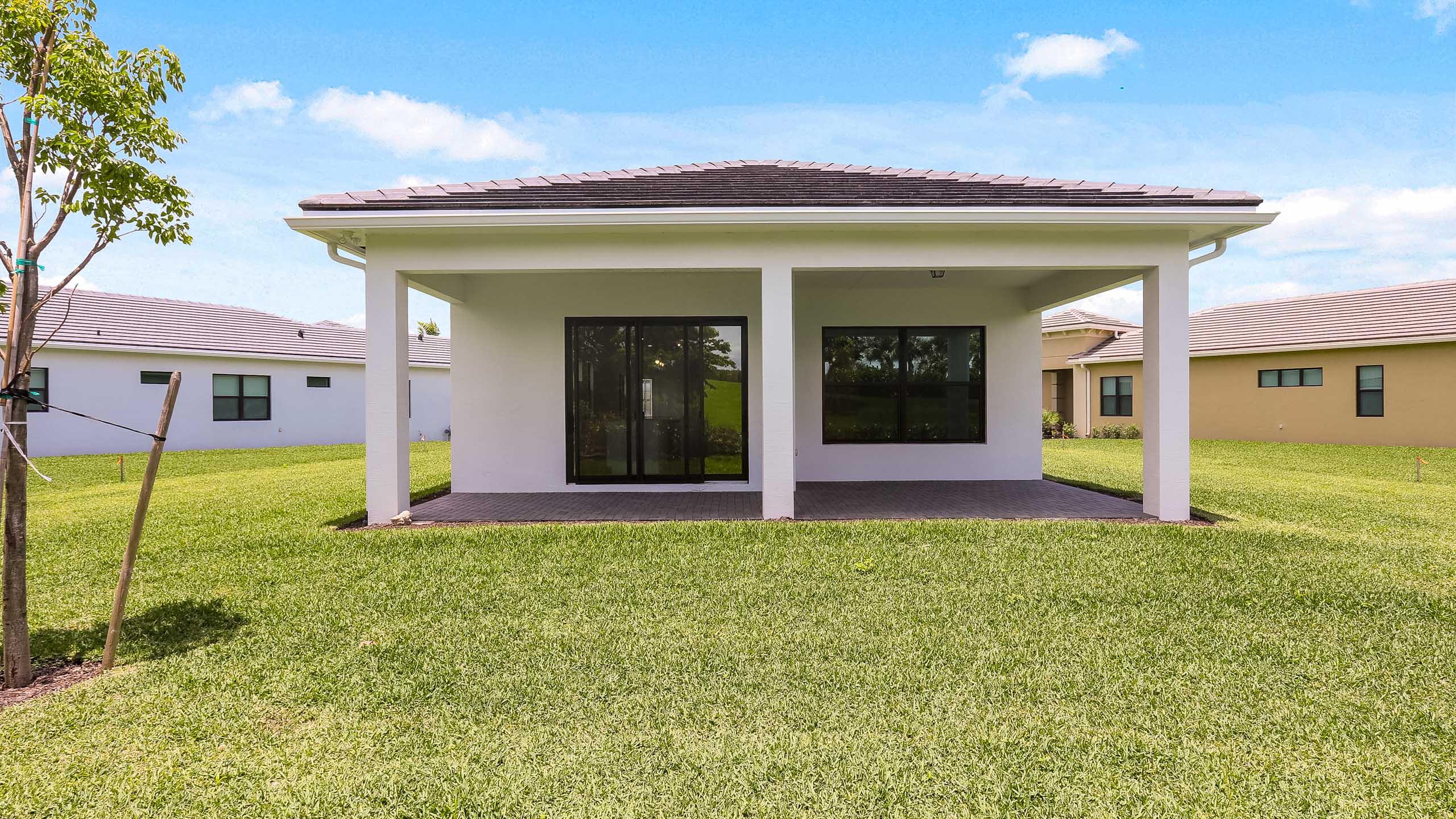15850 Alys Terrace Westlake, FL 33470 - Photo 23 of 26 a view of a house with pool and a yard