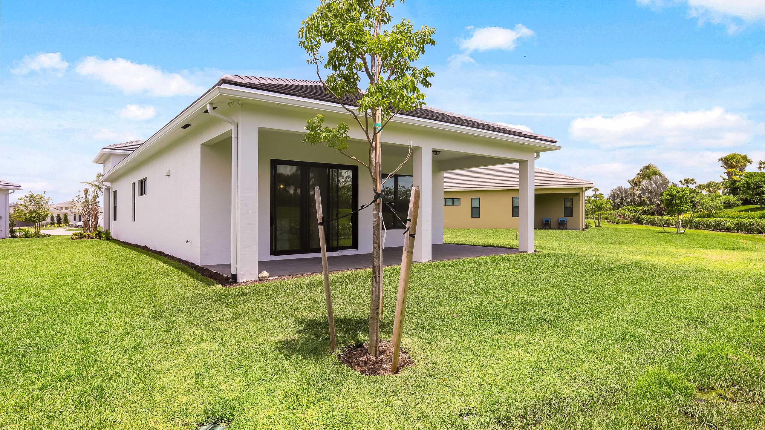 15850 Alys Terrace Westlake, FL 33470 - Photo 24 of 26 a view of a house with backyard and porch