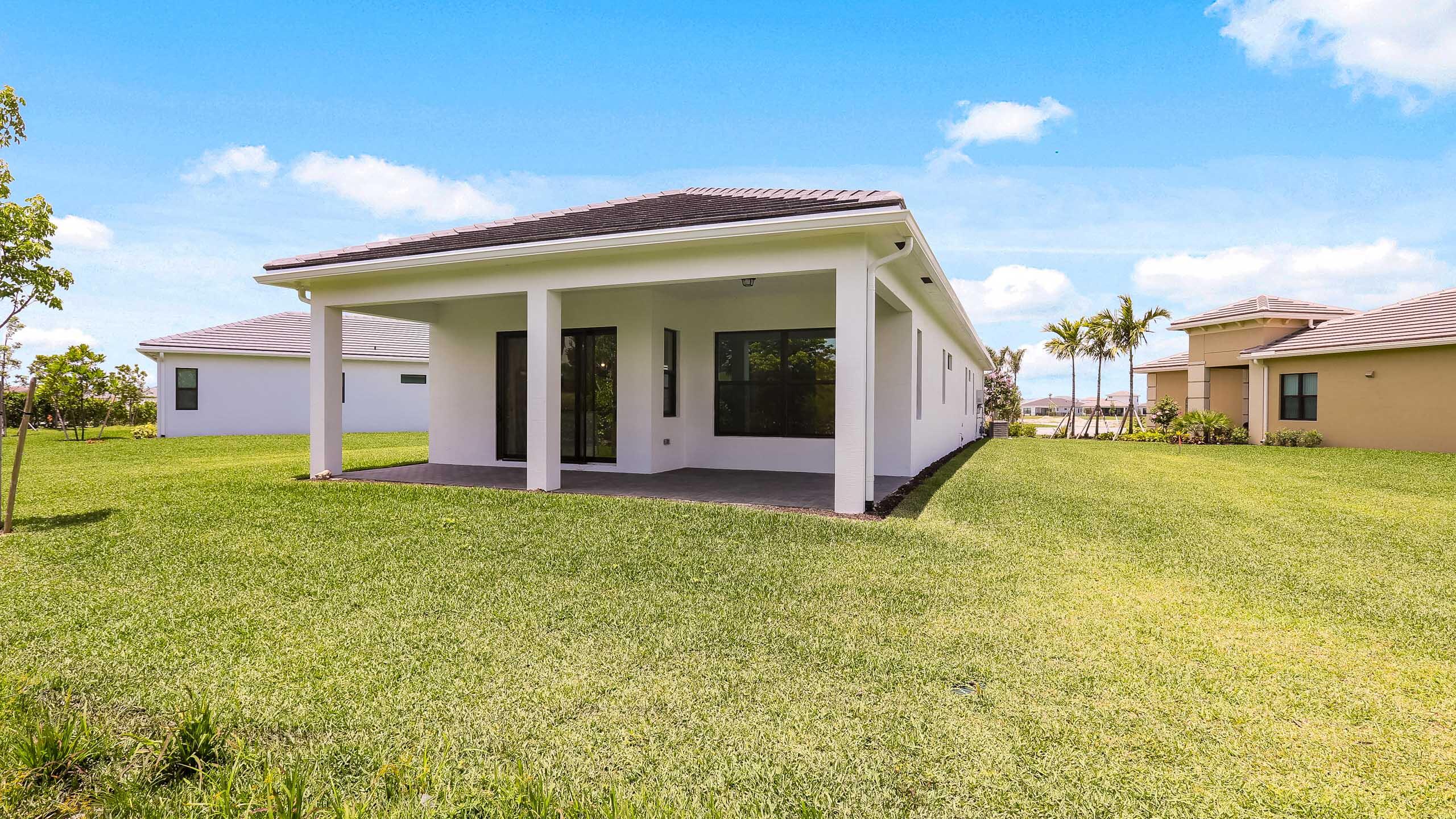 15850 Alys Terrace Westlake, FL 33470 - Photo 25 of 26 a view of a house with backyard and porch