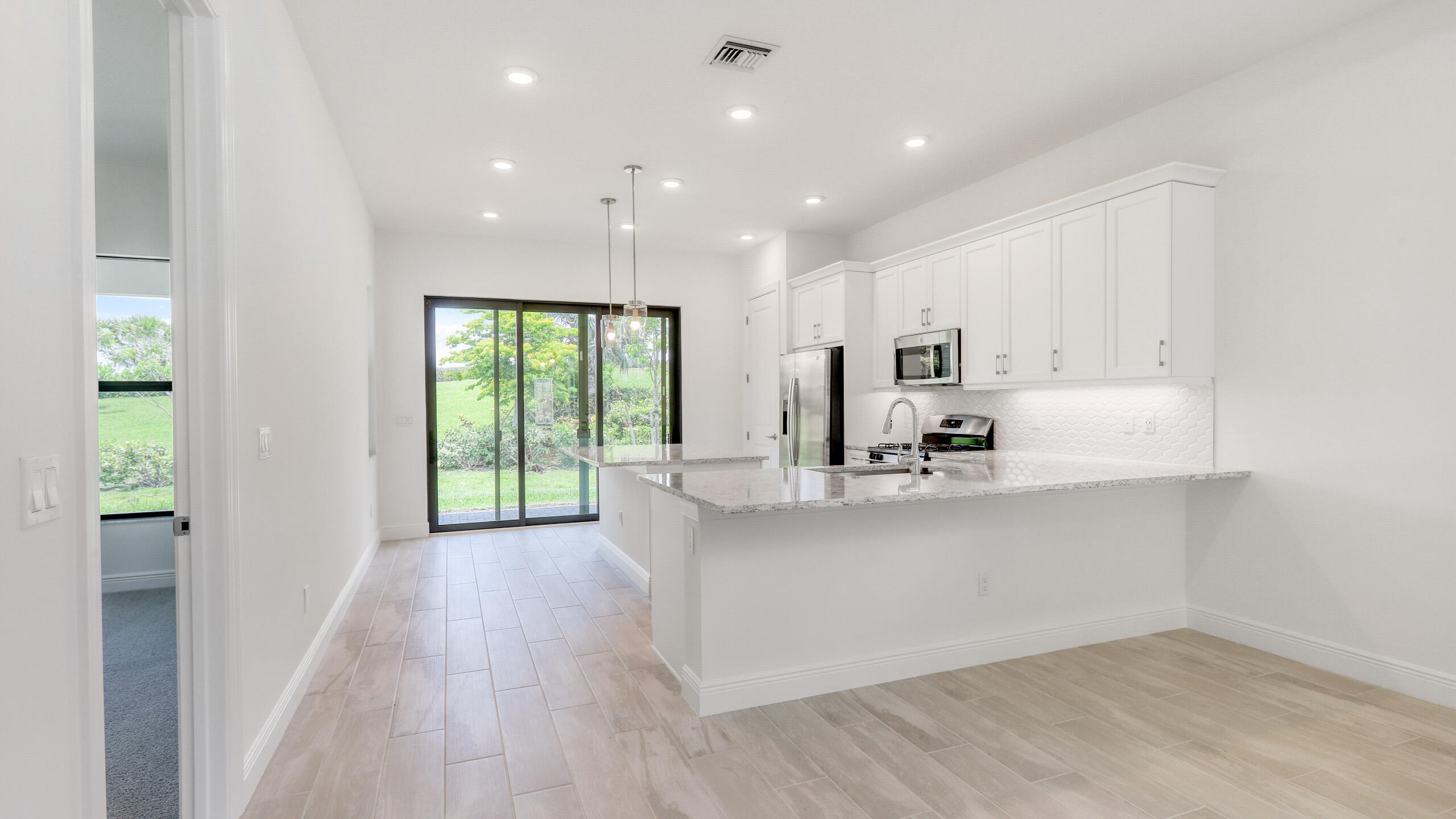15850 Alys Terrace Westlake, FL 33470 - Photo 5 of 26 a large white kitchen with a large window