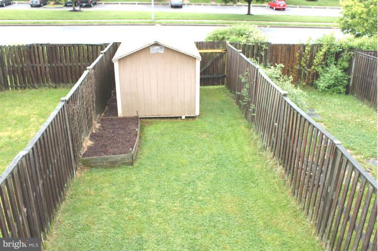 2243 Riding Crop Way Windsor Mill, MD 21244 - Photo 11 of 12 a house view with garden space and wooden deck