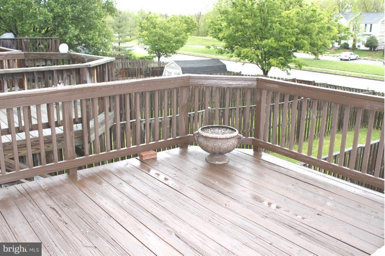 2243 Riding Crop Way Windsor Mill, MD 21244 - Photo 3 of 12 a view of a deck with two chair and wooden floor