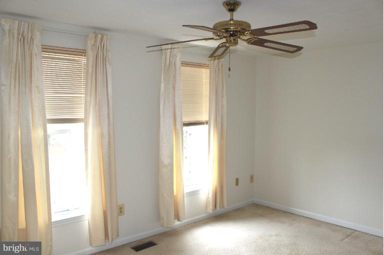 2243 Riding Crop Way Windsor Mill, MD 21244 - Photo 4 of 12 a view of empty room with windows