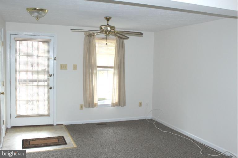 2243 Riding Crop Way Windsor Mill, MD 21244 - Photo 6 of 12 an empty room with windows and cabinet
