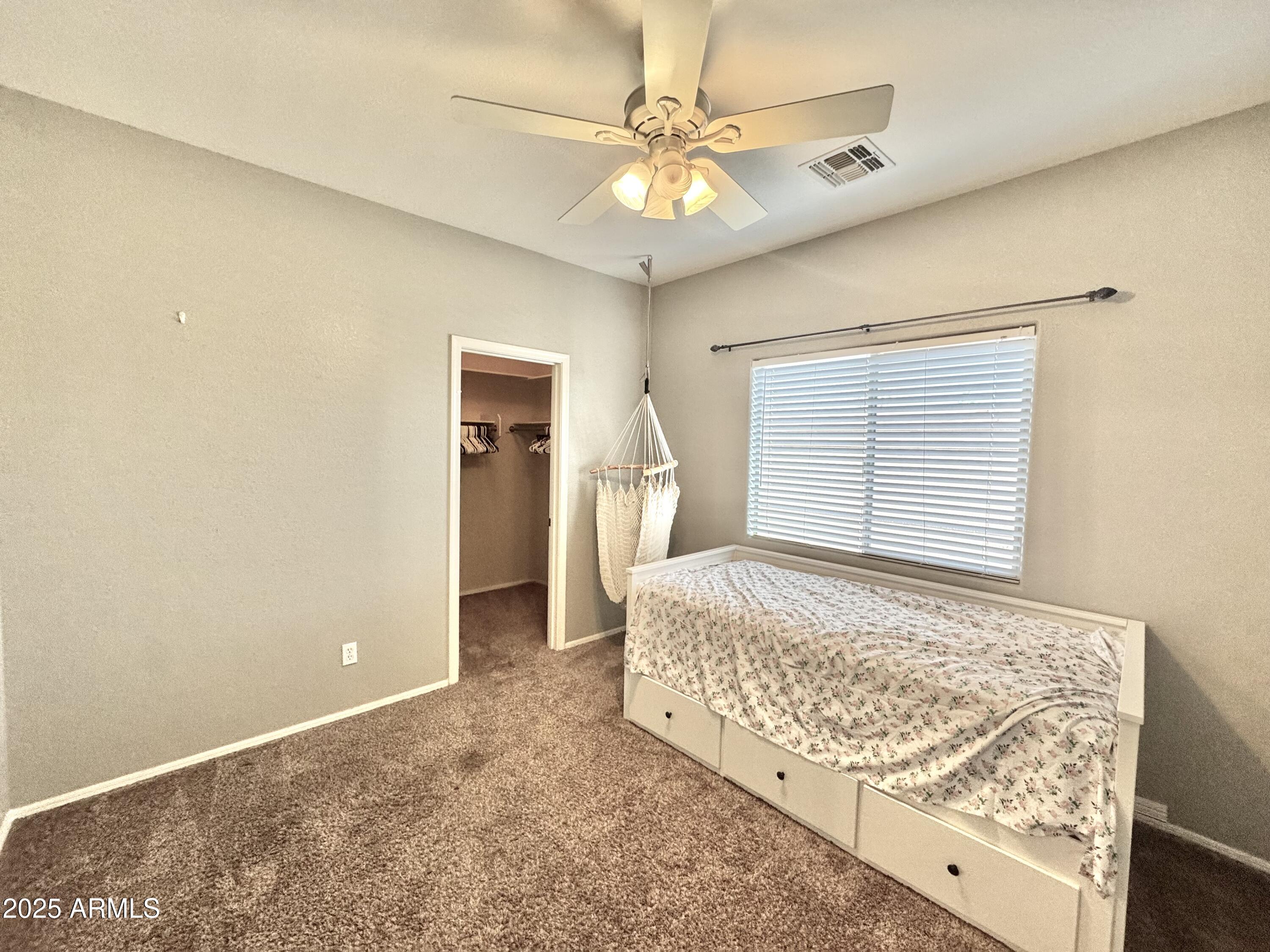 44518 Redrock Road Maricopa, AZ 85139 - Photo 11 of 14 a bedroom with a bed and a chandelier