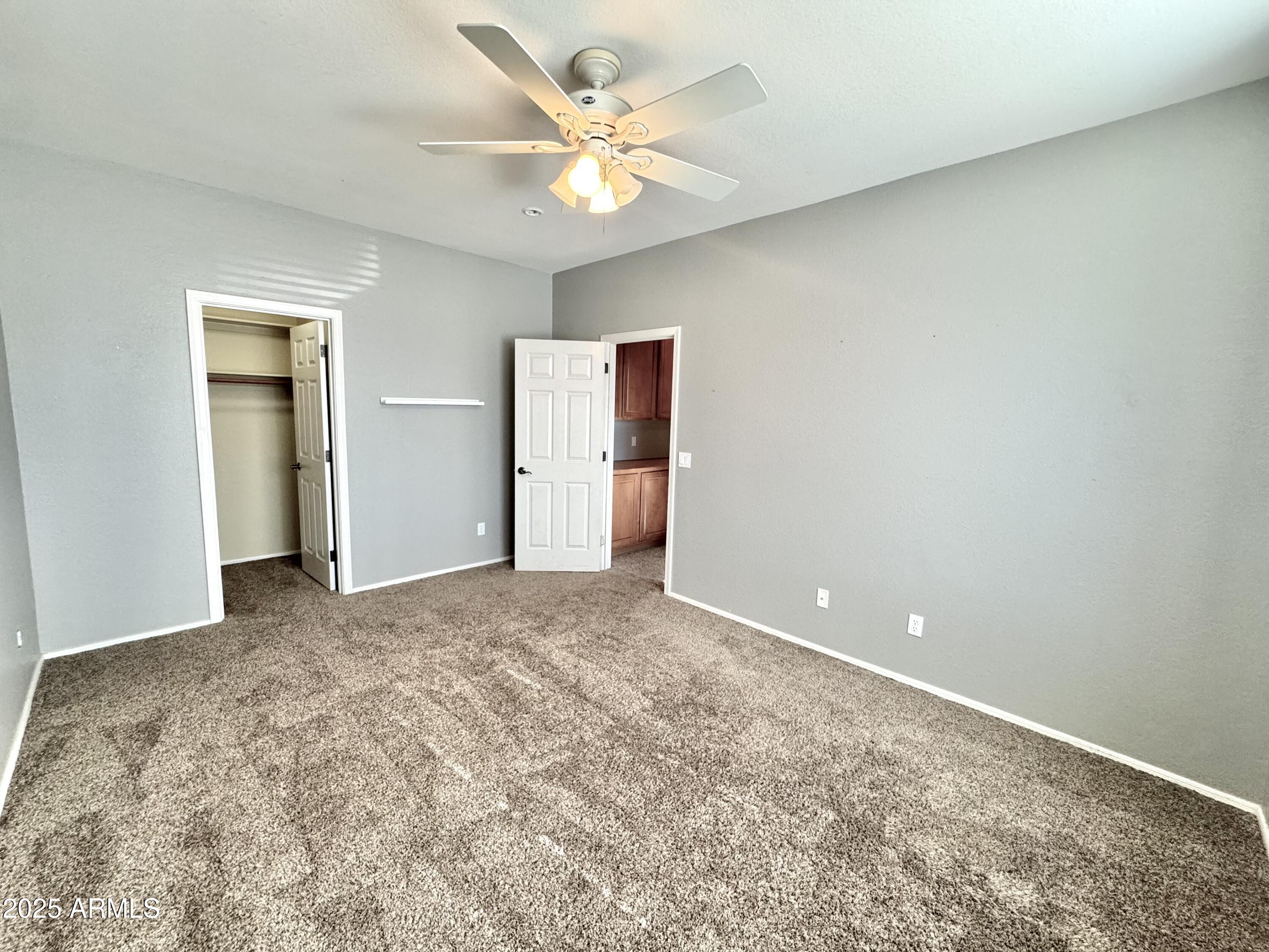44518 Redrock Road Maricopa, AZ 85139 - Photo 13 of 14 a view of a big room with closet and a chandelier fan