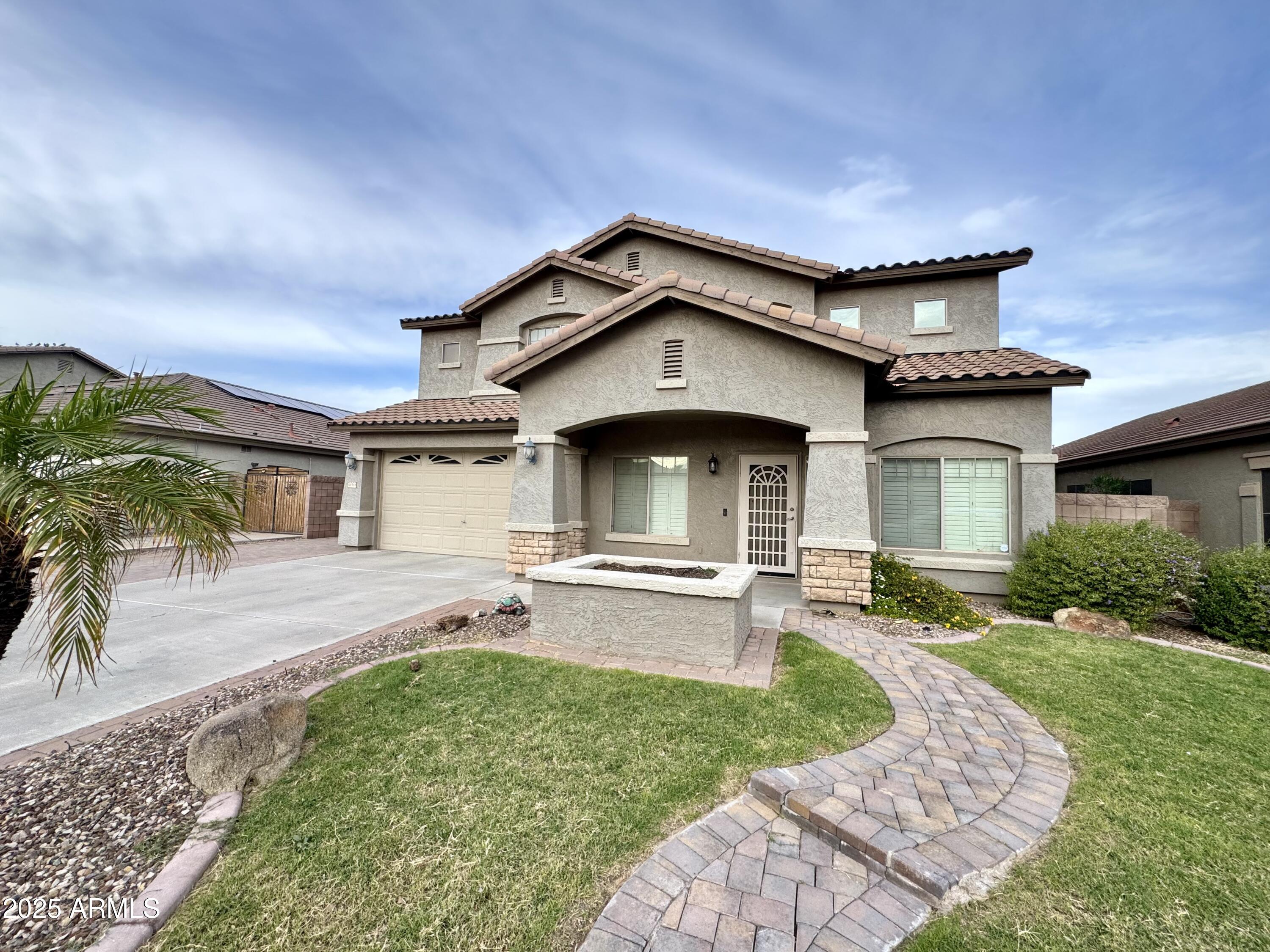 44518 Redrock Road Maricopa, AZ 85139 - Photo 2 of 14 a front view of a house with a garden and yard