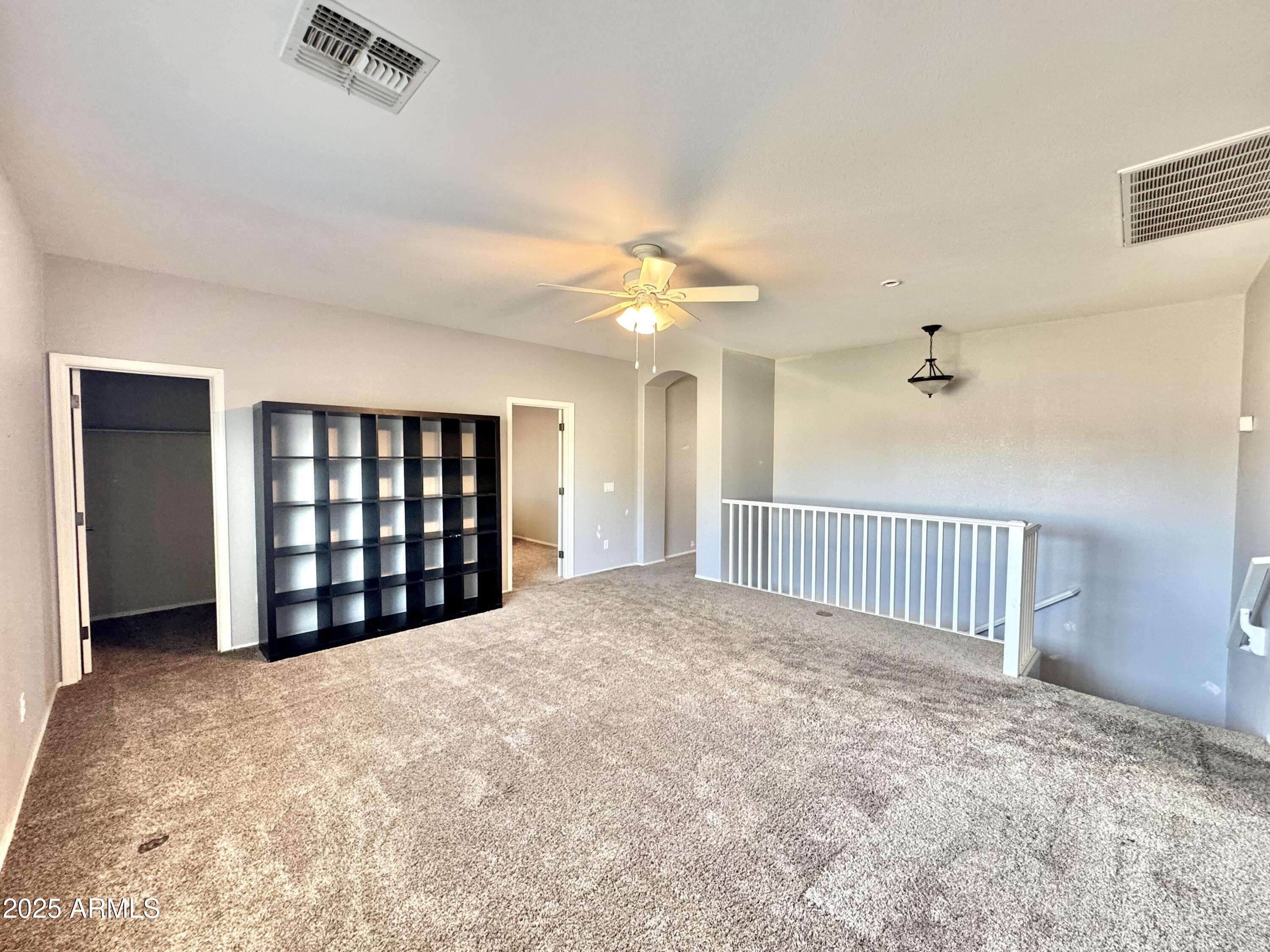 44518 Redrock Road Maricopa, AZ 85139 - Photo 9 of 14 an empty room with windows and ceiling fan