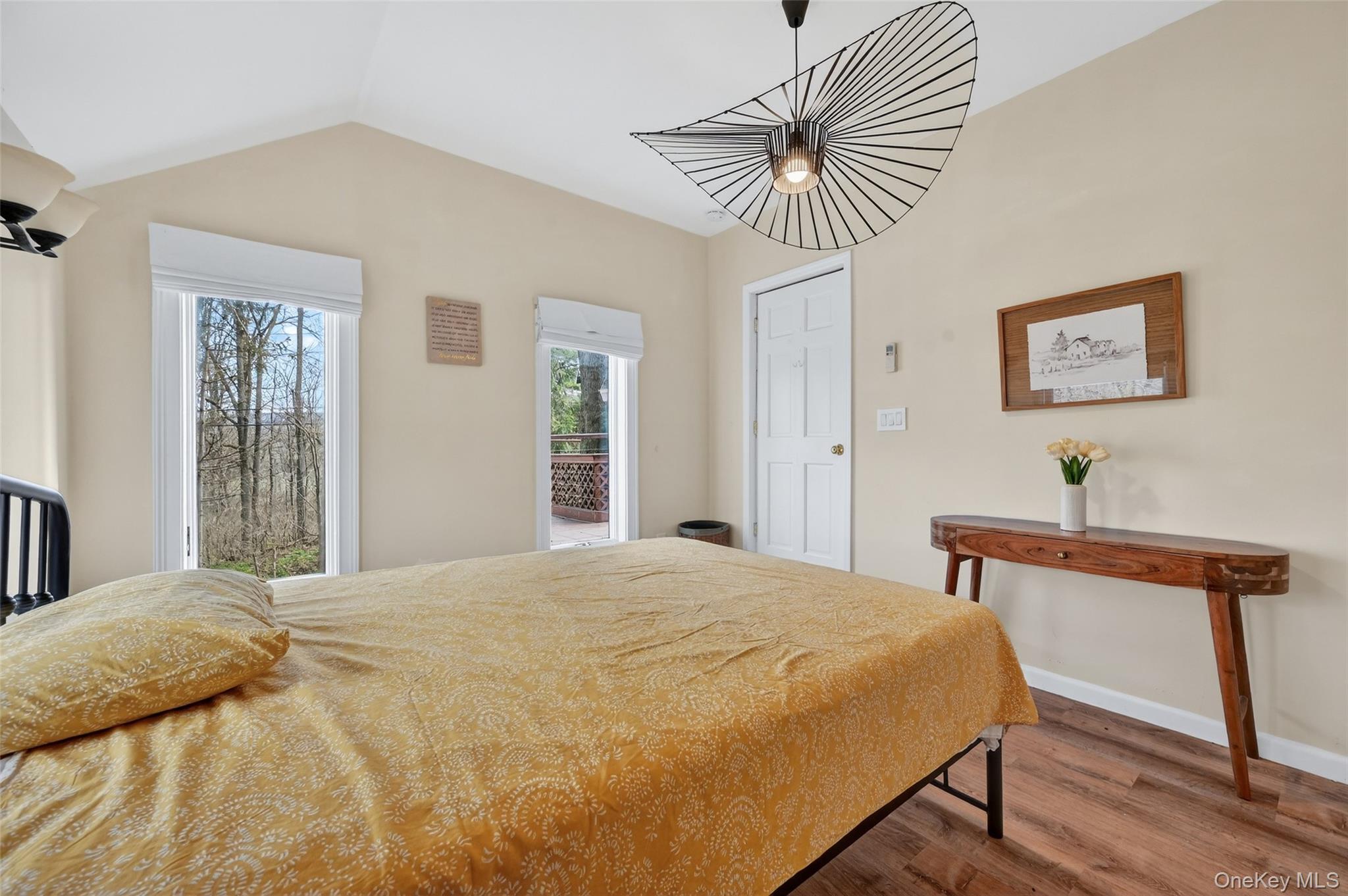 96 Lower Wisner Road Warwick, NY 10990 - Photo 18 of 34 Vaulted ceilings with an architectural light fixture, wood-finish flooring, and two windows offering exterior views