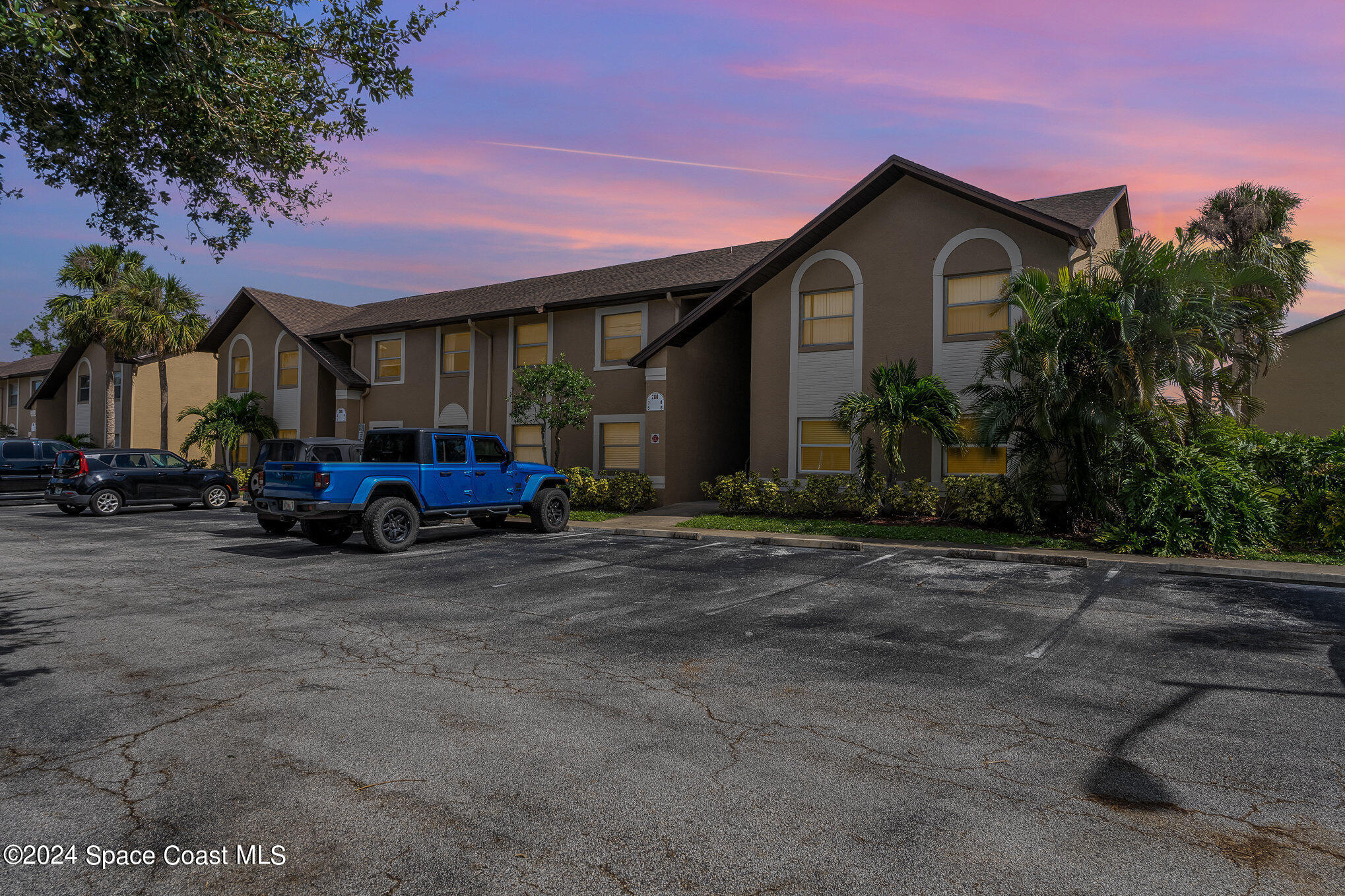 280 Spring Drive, Unit 4 Merritt Island, FL 32953 - Photo 2 of 32 a view of a house with cars parked in front of it