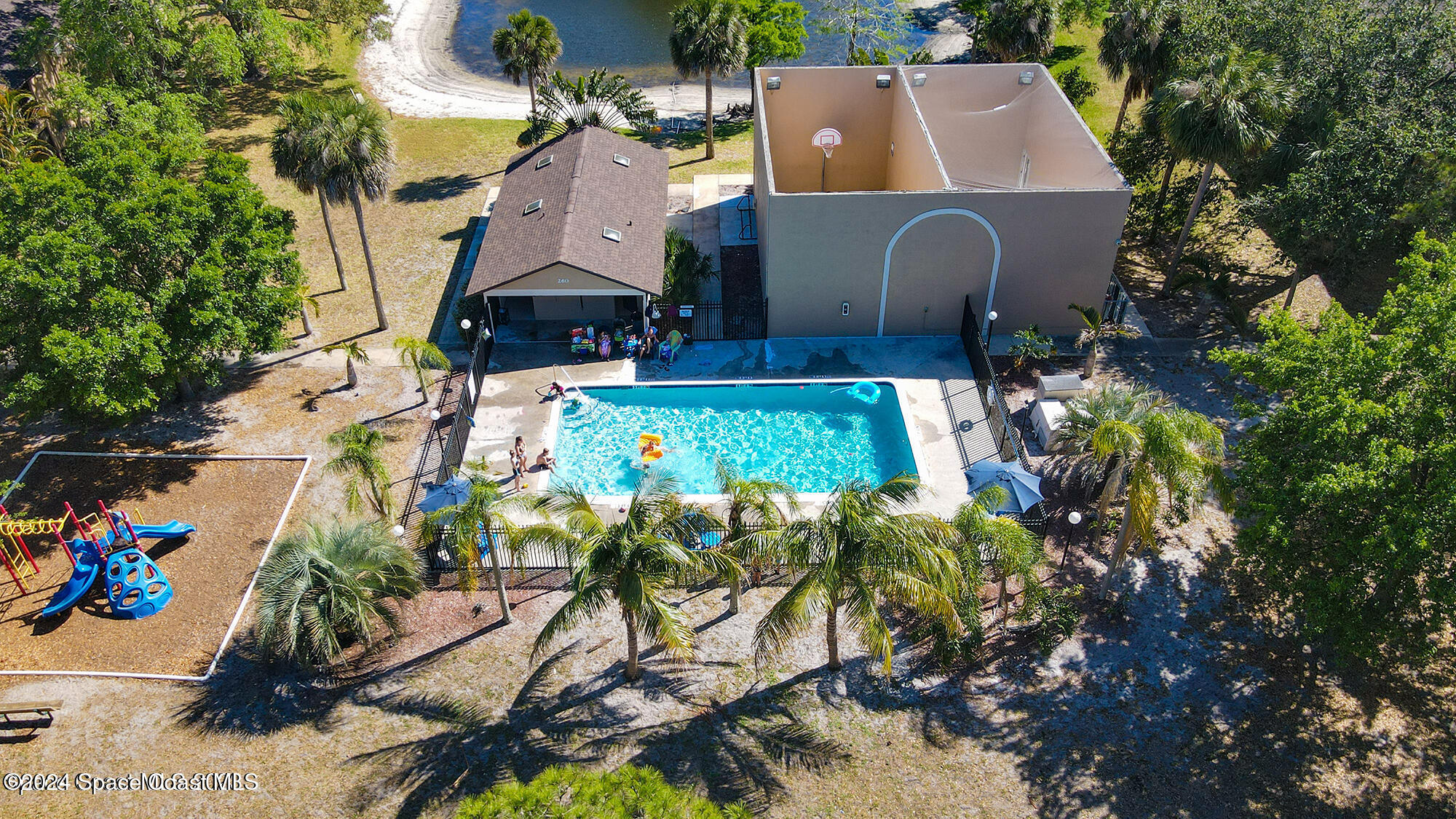 280 Spring Drive, Unit 4 Merritt Island, FL 32953 - Photo 25 of 32 an aerial view of a house with a yard and a bench