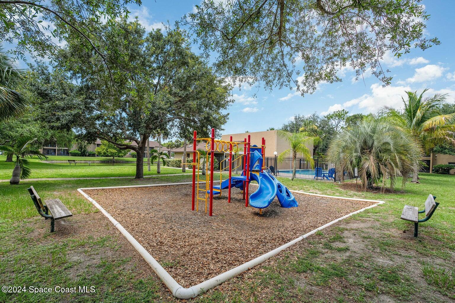 280 Spring Drive, Unit 4 Merritt Island, FL 32953 - Photo 26 of 32 a view of a park with swings and slides