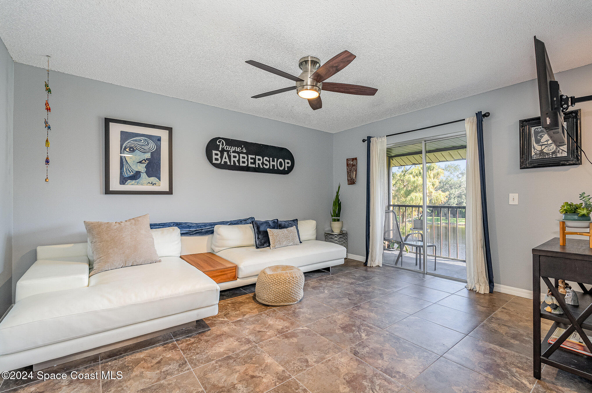 280 Spring Drive, Unit 4 Merritt Island, FL 32953 - Photo 5 of 32 a living room with furniture and a window