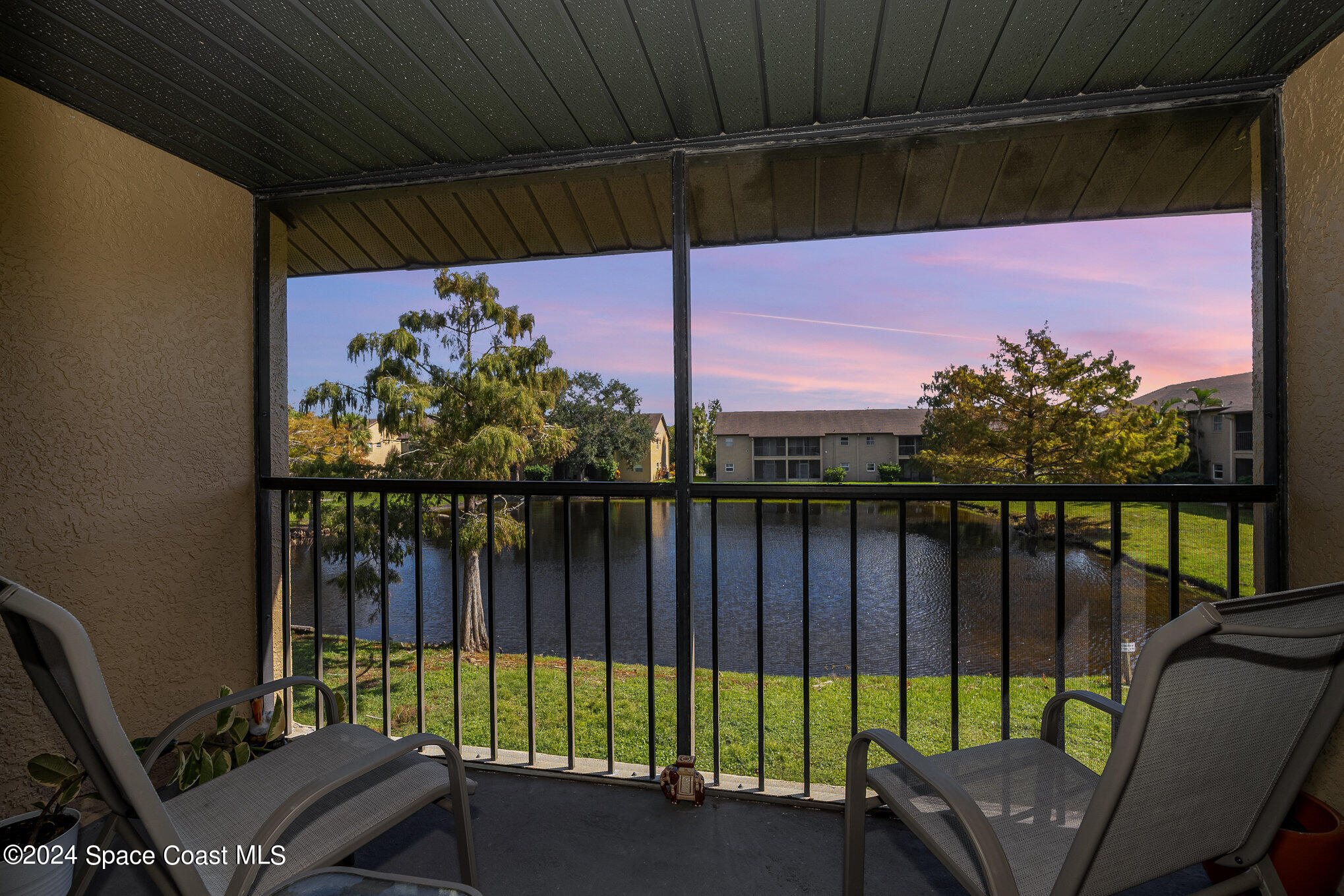 280 Spring Drive, Unit 4 Merritt Island, FL 32953 - Photo 6 of 32 a view of a balcony with furniture and a floor to ceiling window