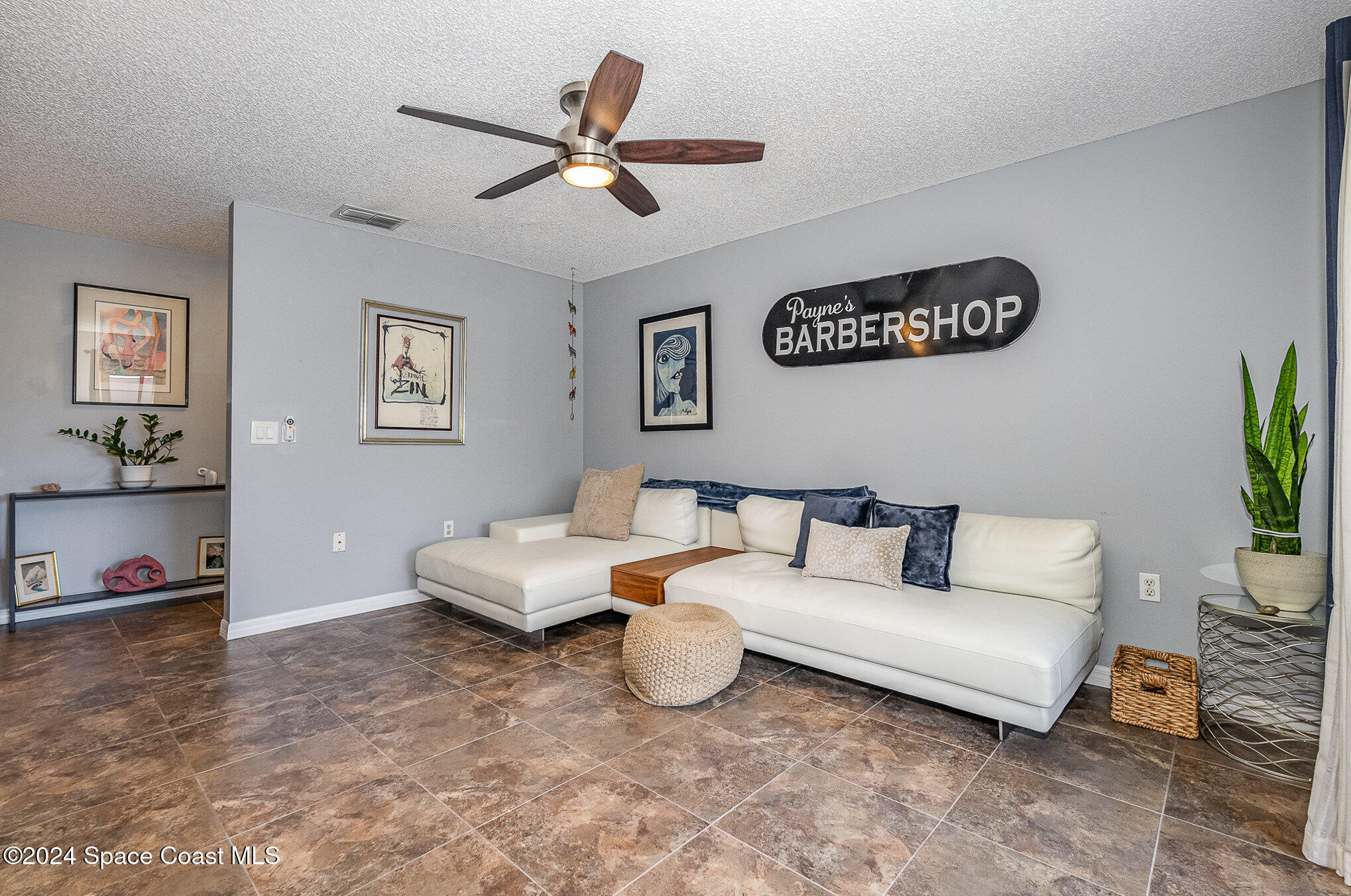 280 Spring Drive, Unit 4 Merritt Island, FL 32953 - Photo 7 of 32 a living room with furniture and a ceiling fan