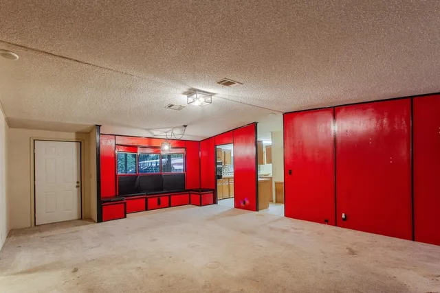 a view of an empty room with a ceiling fan