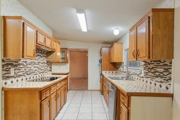 a kitchen with stainless steel appliances granite countertop a sink and a stove