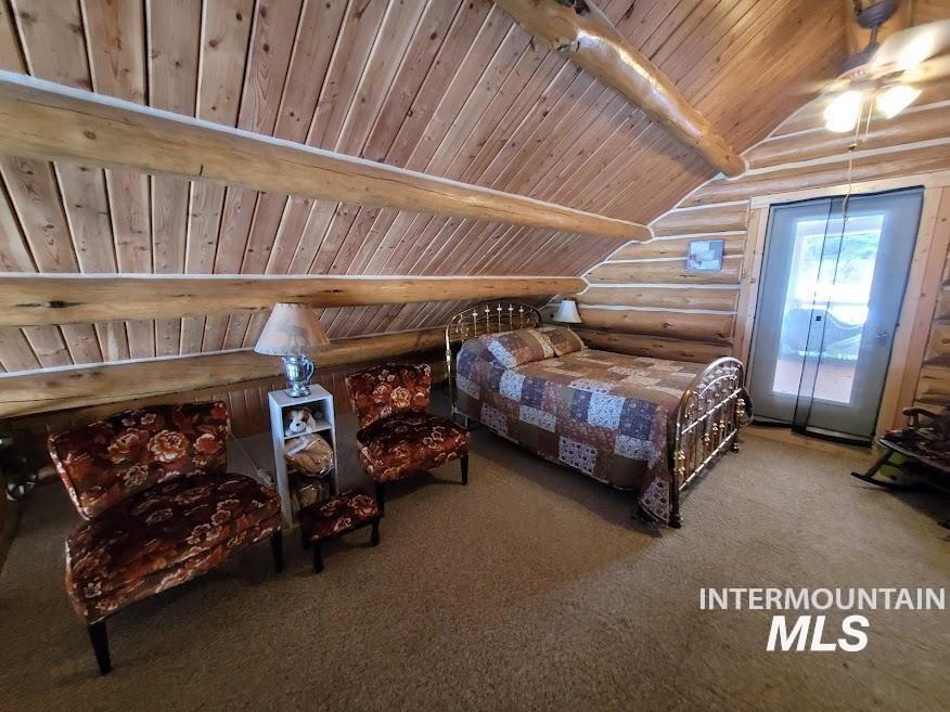 112 Three Forks Road Kamiah, ID 83536 - Photo 21 of 45 Carpeted bedroom with rustic walls, wooden ceiling, access to exterior, vaulted ceiling with beams, and ceiling fan