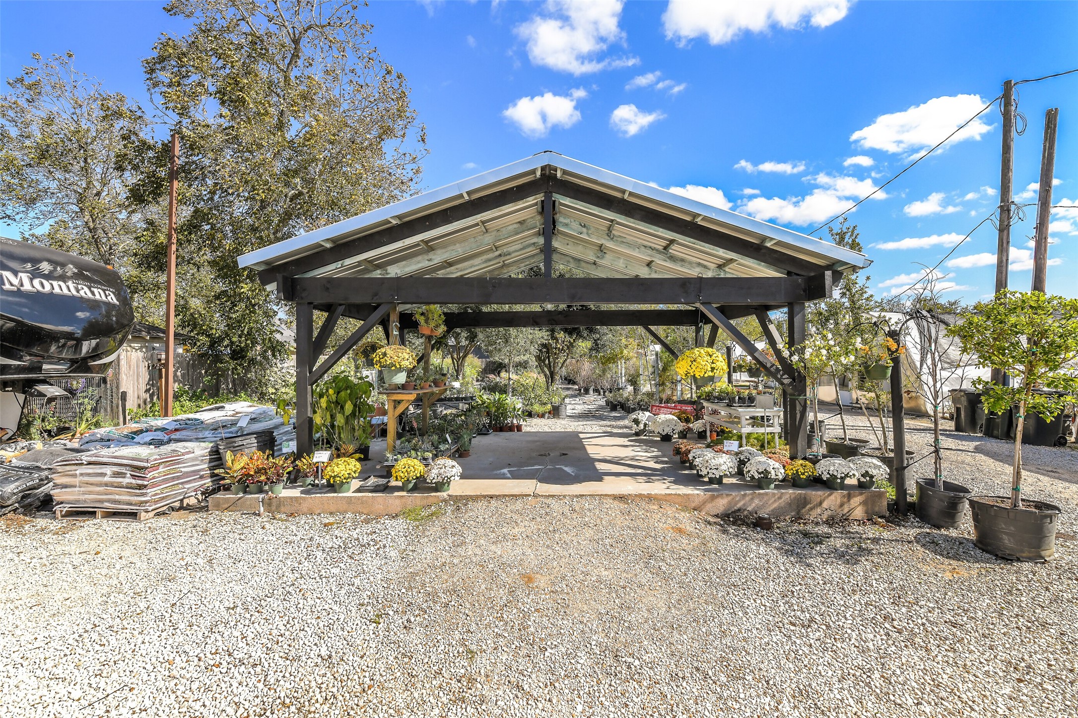 511 West Main Street Weimar, TX 78962 - Photo 13 of 30 a view of a patio with table and chairs under an umbrella