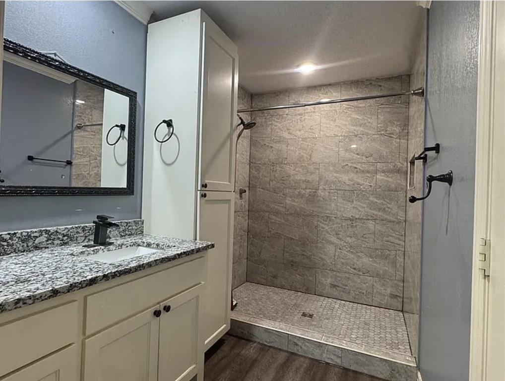 8261 County Road 381 Tyler, TX 75708 - Photo 32 of 40 a bathroom with a shower sink and mirror