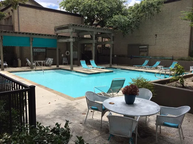 a view of a backyard with table and chairs and potted plants