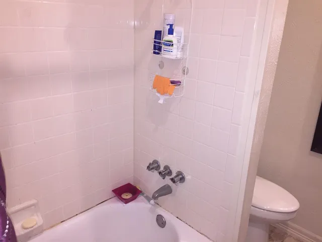 a view of walk in closet with clothes