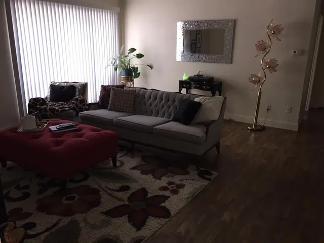 a living room with furniture and wooden floor