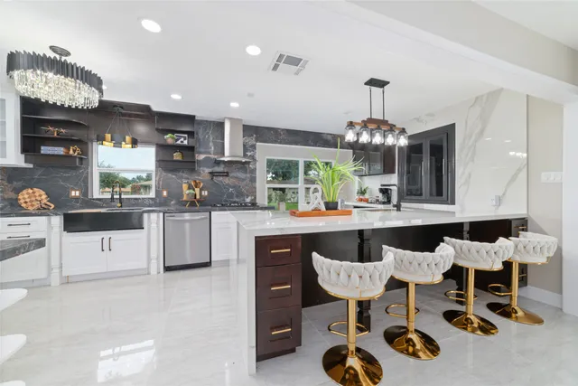 a kitchen with granite countertop a table and chairs in it
