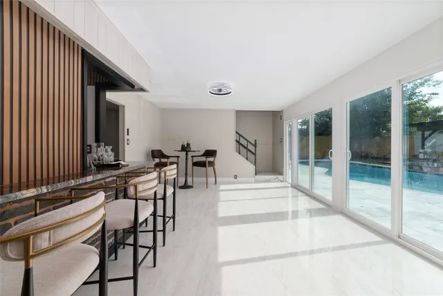 a view of a room with lots of chairs and mirrors