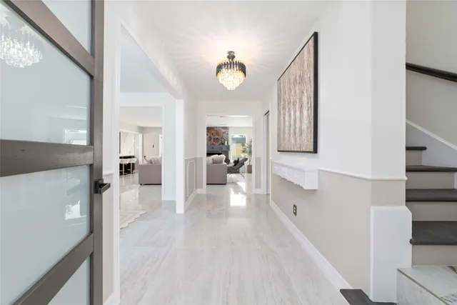 a view of a hallway view with wooden floor and staircase