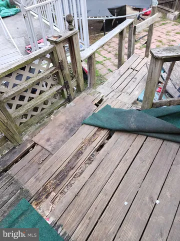 a roof deck with table and chairs potted plants with wooden floor