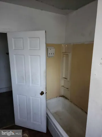a bathroom with a bathtub sink vanity mirror and toilet
