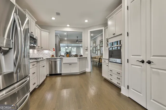 a kitchen with stainless steel appliances a refrigerator sink and microwave