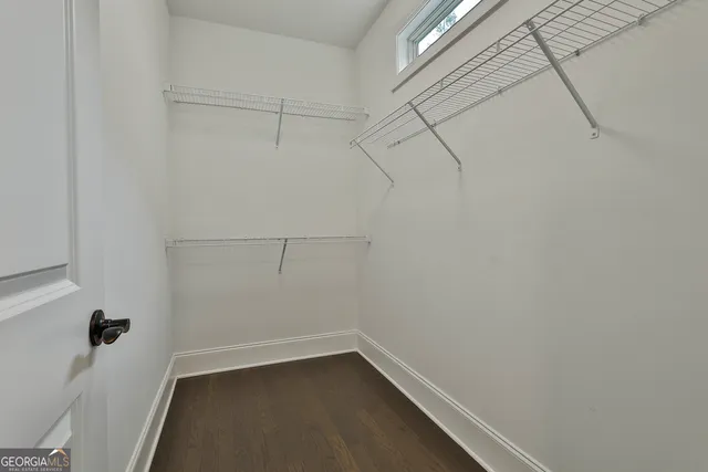 a bed room with a bed and painting on the wall