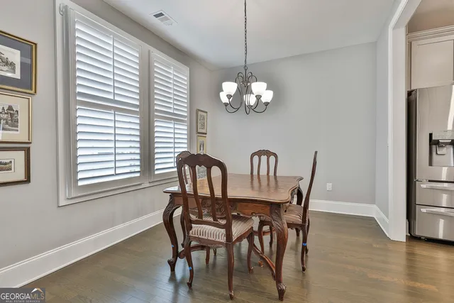 a view of a dining room with furniture wooden floor and chandelier