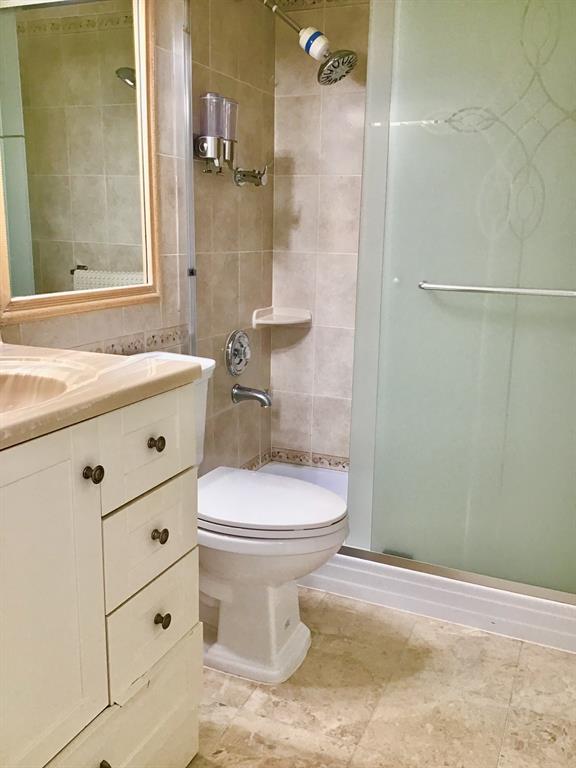 2038 Exeter C, Unit 2038 Boca Raton, FL 33434 - Photo 13 of 37 a bathroom with a sink a toilet and shower